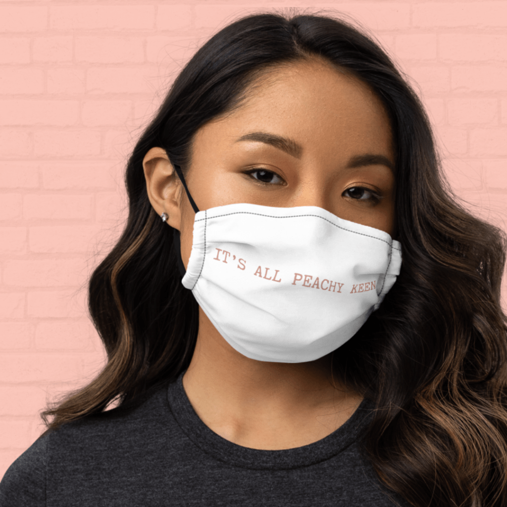 white face mask that says "it's all peachy keen"